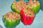 Bell peppers stuffed with cooked chicken and white rice.