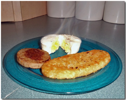 Poached egg with sausage and hash browns. Click on image to view larger size in a new window.