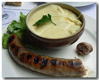 Aligot (Mashed Potatoes with Cheese) served with sausage.