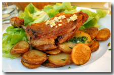 Confit de Canard (Confit Duck Legs) with fried potatoes.